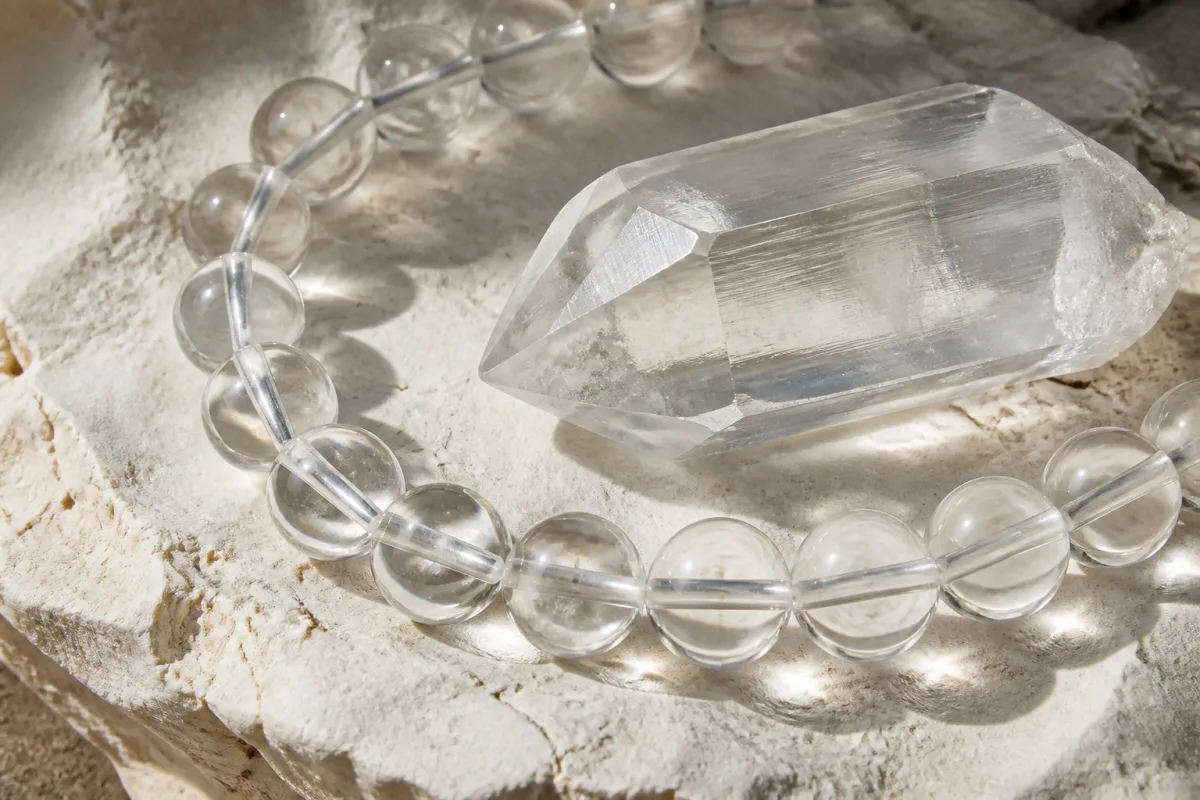 Clear quartz beads and a natural quartz specimen